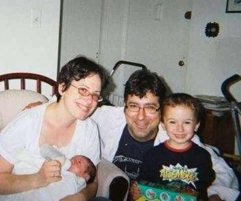 Picture of Dareh Ardashes Gregorian with wife Maggie Haber Man with his son and a a newly born child posing for a photo in his luxurious house.